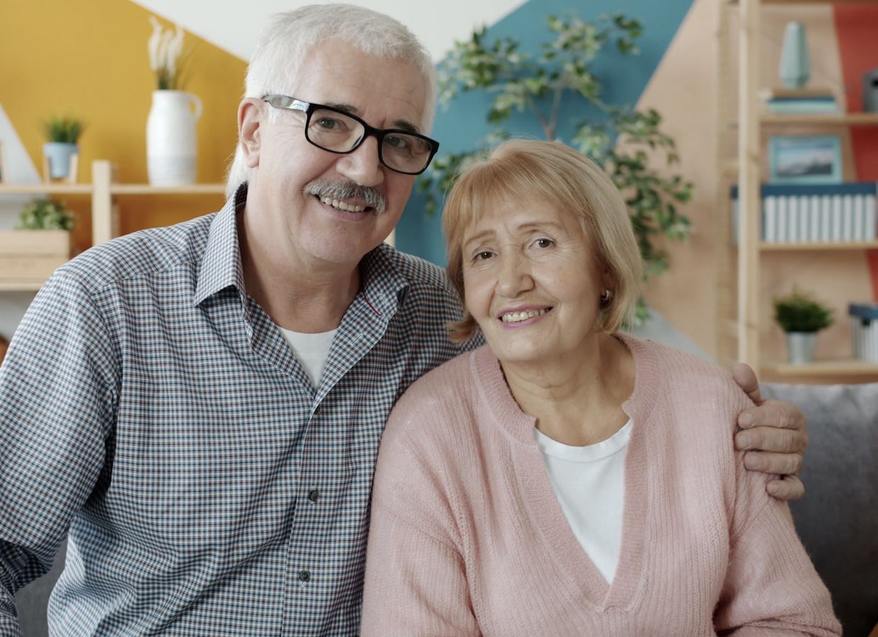 A smiling older couple sitting together